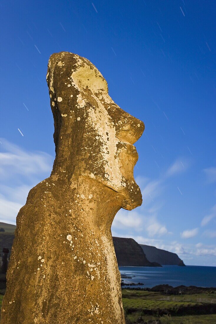 Lone monolithic giant stone Moai statue looking out to sea at Tongariki, Rapa Nui (Easter Island), UNESCO World Heritage Site, Chile, South America
