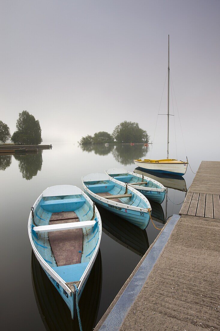 Pleasure boats moored at Llangorse Lake on a misty morning, Brecon Beacons National Park, Powys, Wales, United Kingdom, Europe