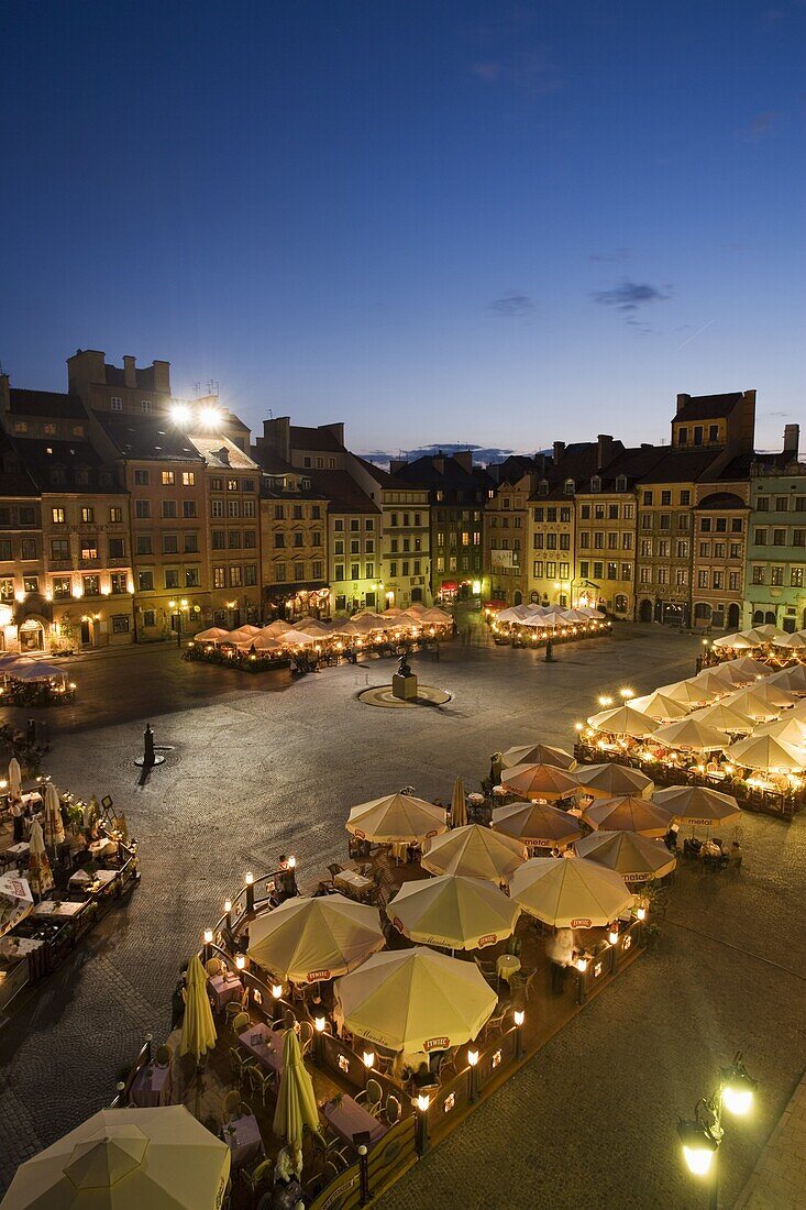 Elevated view over the square and outdoor restaurants and cafes at dusk Old Town Square (Rynek Stare Miasto), UNESCO World Heritage Site, Warsaw, Poland, Europe