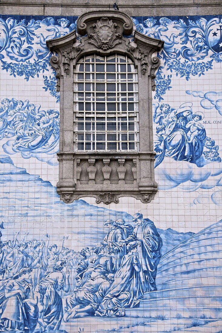 Detail of azulejos (earthenware tiles) on an outside wall of the 18th century Do Carmo church. Oporto, Portugal, Europe