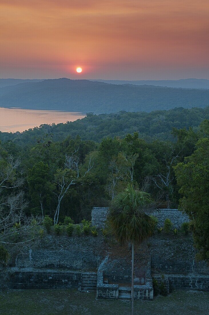 View of sunset over Lake Yaxha from Temple 216, Yaxha, Guatemala, Central America