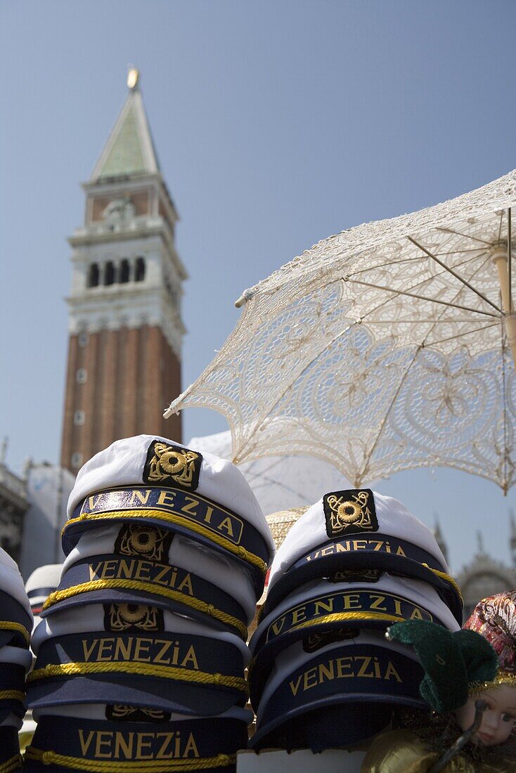 Captain's hats and sun umbrellas for sale in St. Mark's Square, Venice, Veneto, Italy, Europe