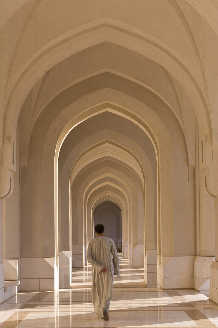 Man walking along a passageway in the Sultan's Palace, Muscat, Oman, Middle East