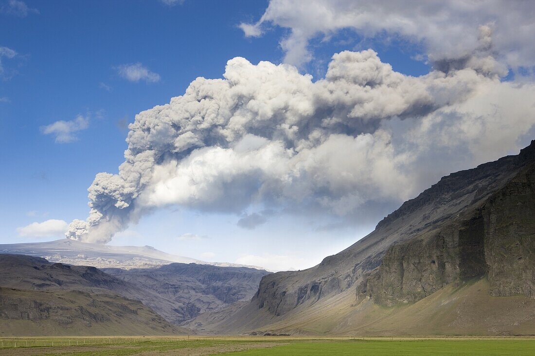 Distant view towards mountains with the ash plume of the Eyjafjallajokull eruption in the distance, near Hella, southern area, Iceland, Polar Regions