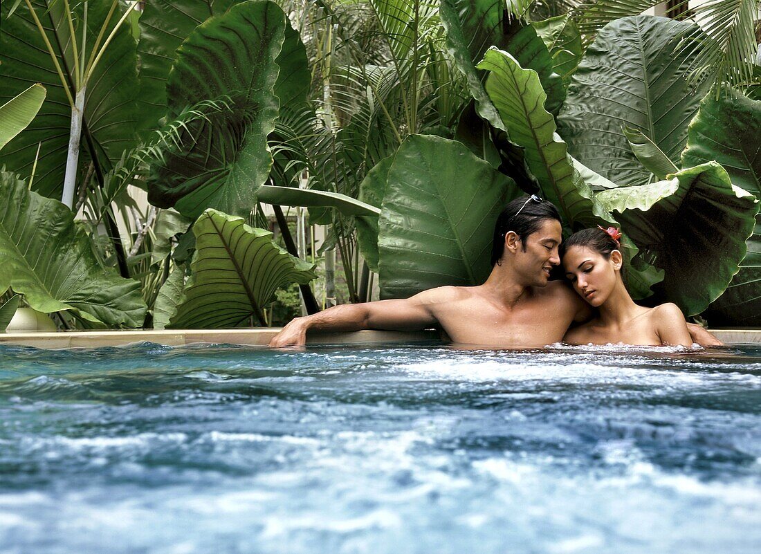 Couple in a hot tub, Maldives, Indian Ocean, Asia