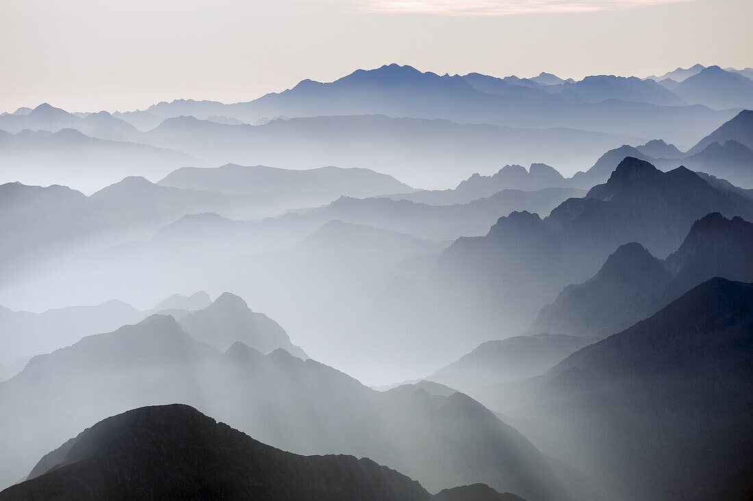 Mountains silhouetted at sunrise, view from Pico de Aneto, at 3404m the highest peak in the Pyrenees, Spain, Europe