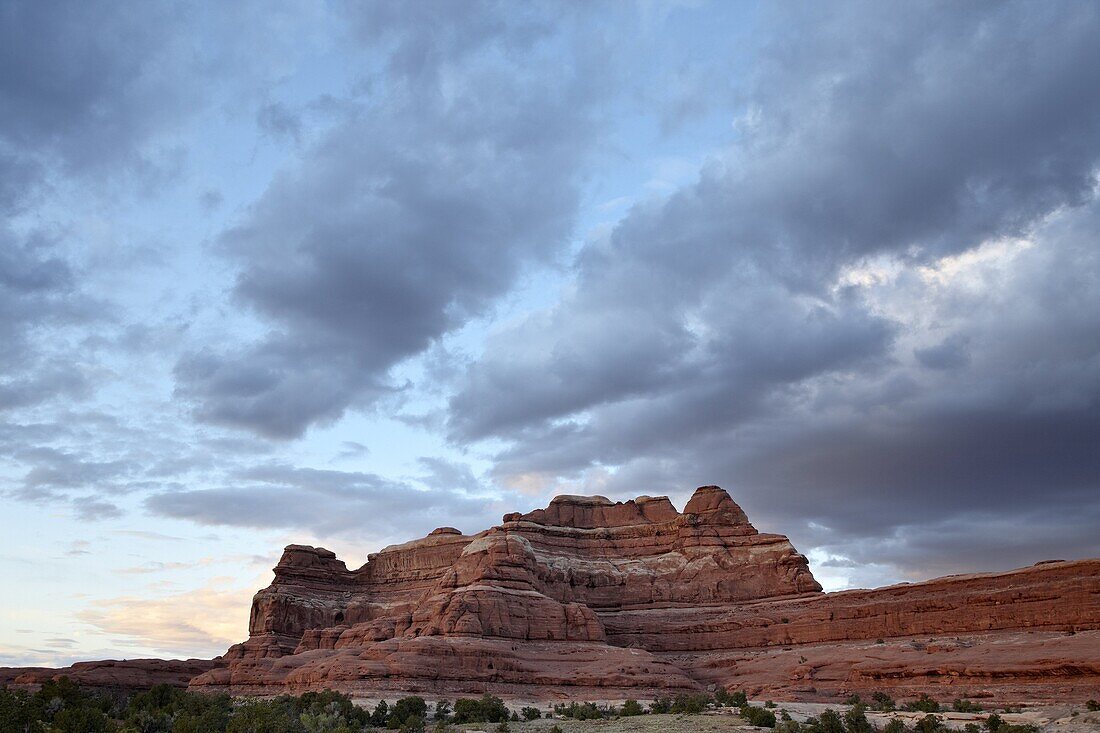 Red rock formation at sunset with clouds, The Needles District, Canyonlands National Park, Utah, United States of America, North America