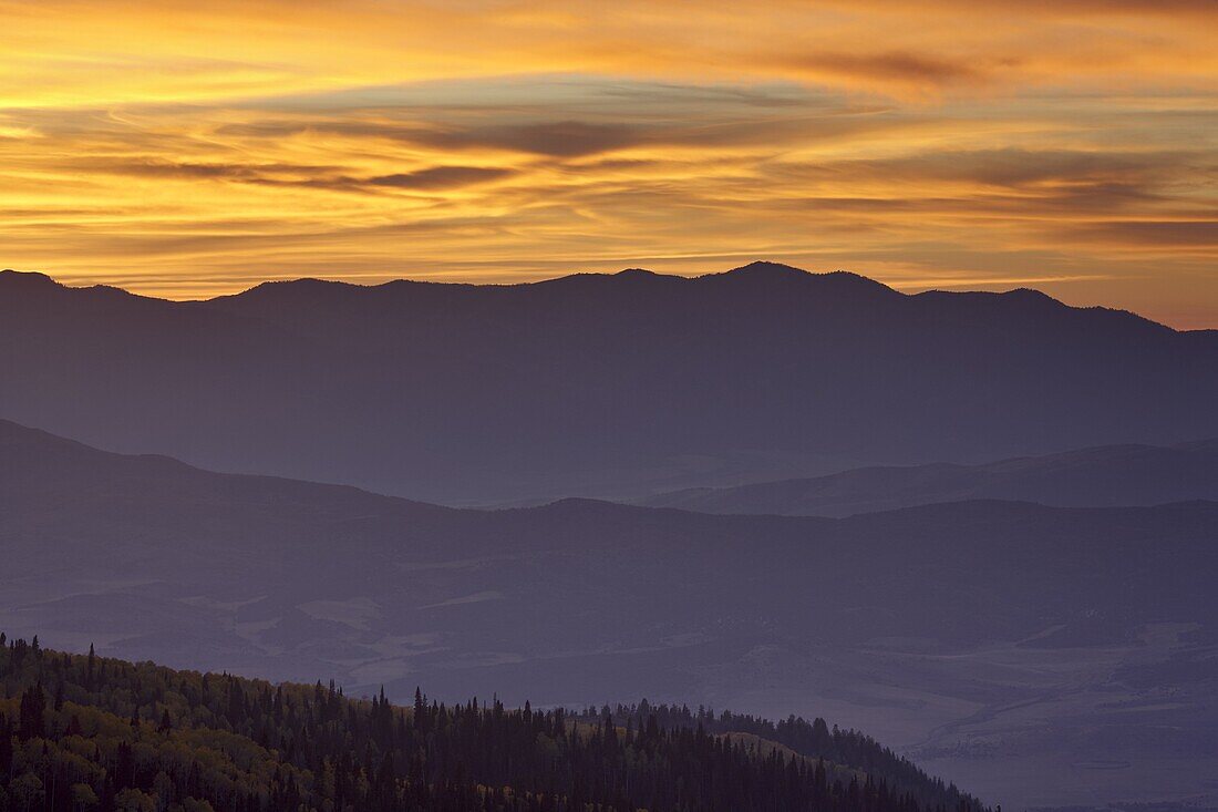 Orange clouds at sunset over layered mountains, Manti-La Sal National Forest, Utah, United States of America, North America