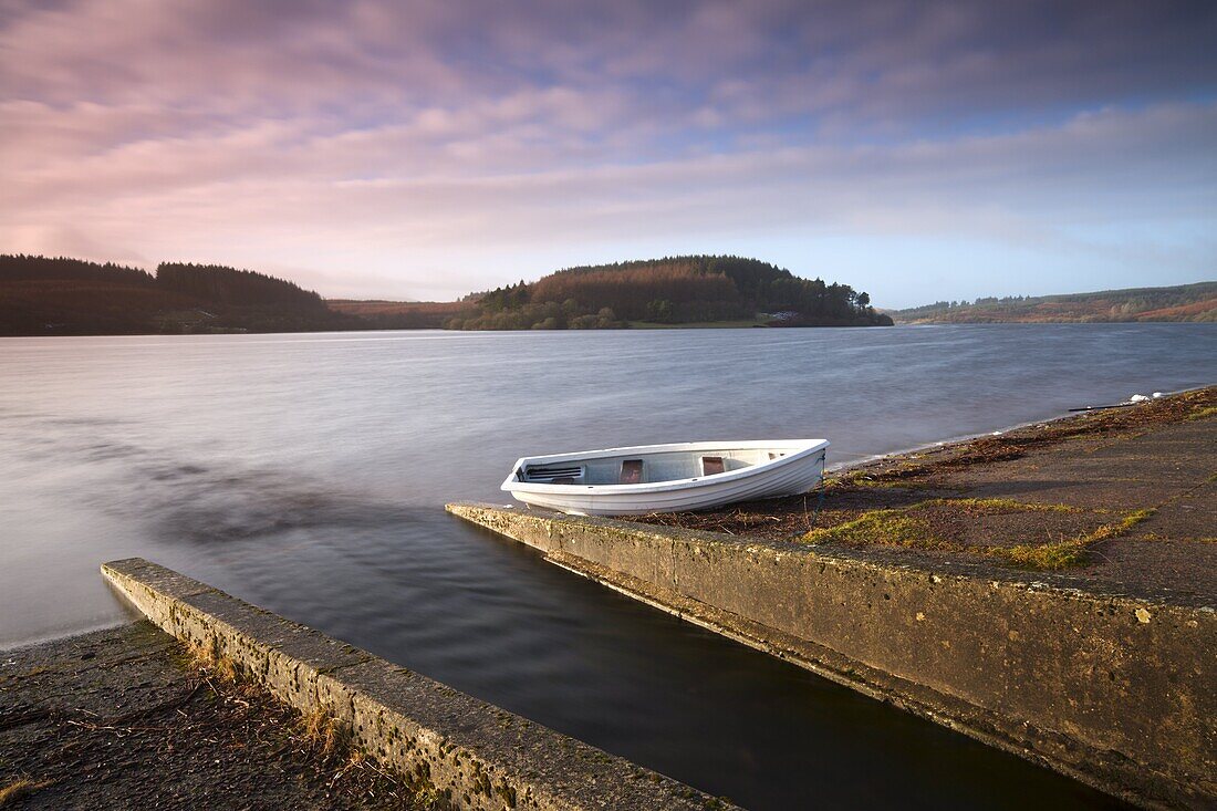 Usk reservoir outflow and boat, in winter, Brecon Beacons National Park, Wales, United Kingdom, Europe