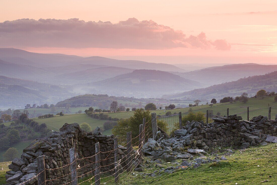 Dry stone wall on the slopes of Sugar Loaf mountain, looking towards the Usk Valley at sunset, Brecon Beacons National Park, Monmouthshire, Wales, United Kingdom, Europe