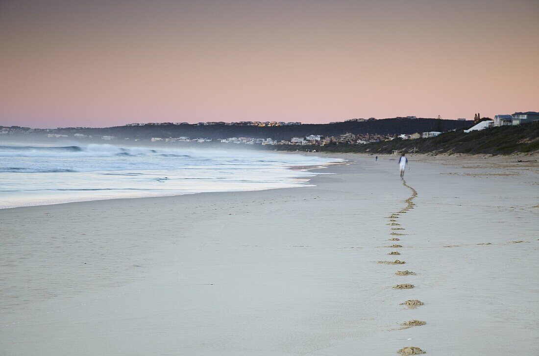 Man jogging on beach at dawn, Plettenberg Bay, Western Cape, South Africa, Africa