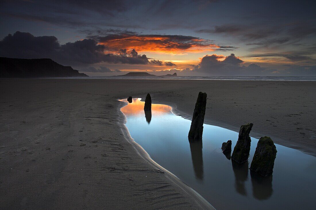 Beachside at Rhossili Bay, with the wreck of the Helvetia buried in the sand and Worm's Head on the horizon, Rhossili Bay, Gower, Wales, United Kingdom, Europe