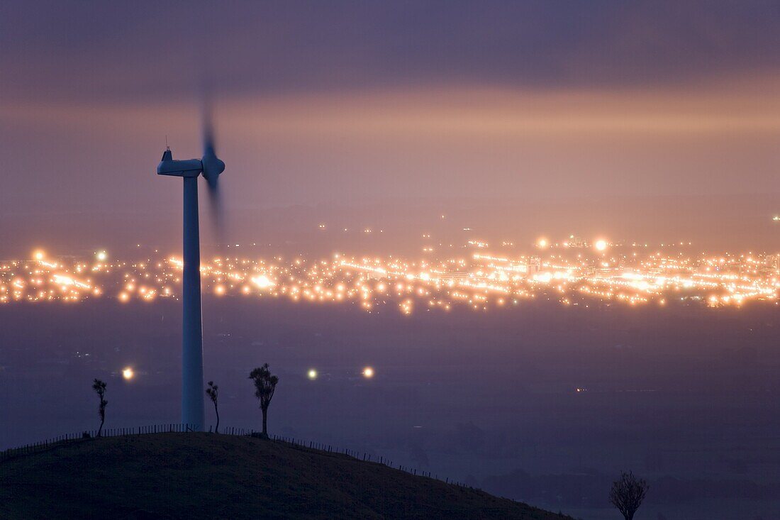 Te Apiti Wind Farm at dawn, on the lower Ruahine Ranges, with the lights of Palmerston North beyond, Manawatu, North Island, New Zealand, Pacific