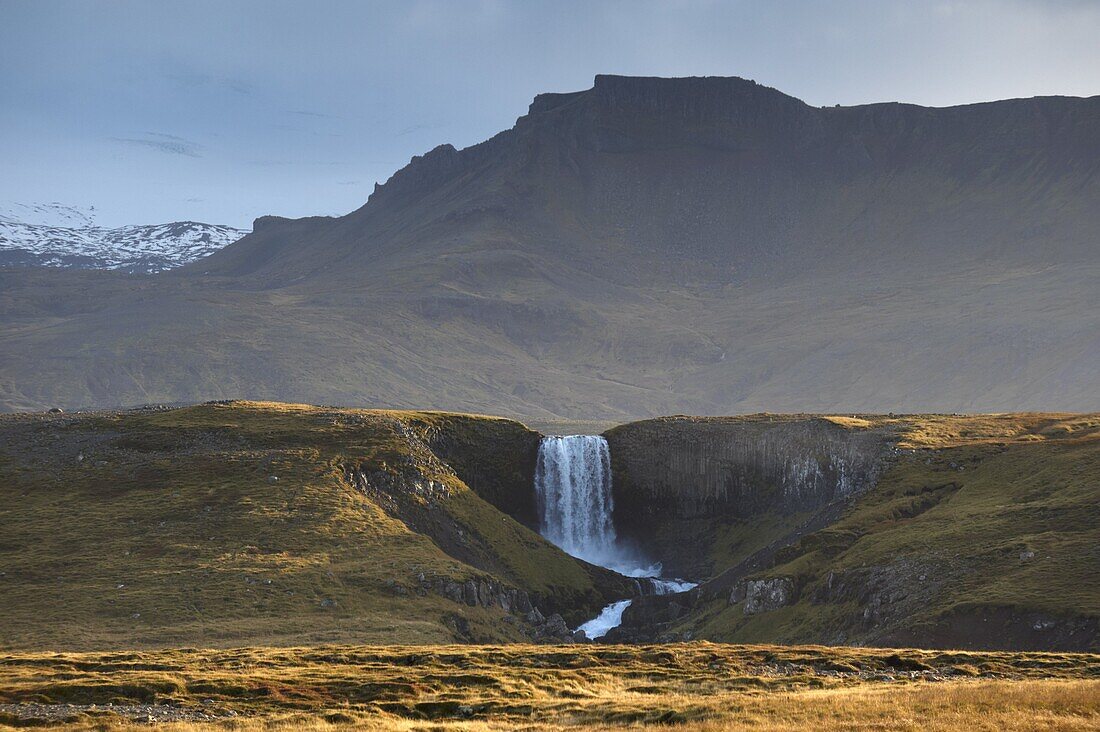 Waterfall in Snaefellsjokull National Park, Snaefellsjokull behind, covered in clouds, near Hellisandur, Snaefellsnes Peninsula, Iceland, Polar Regions