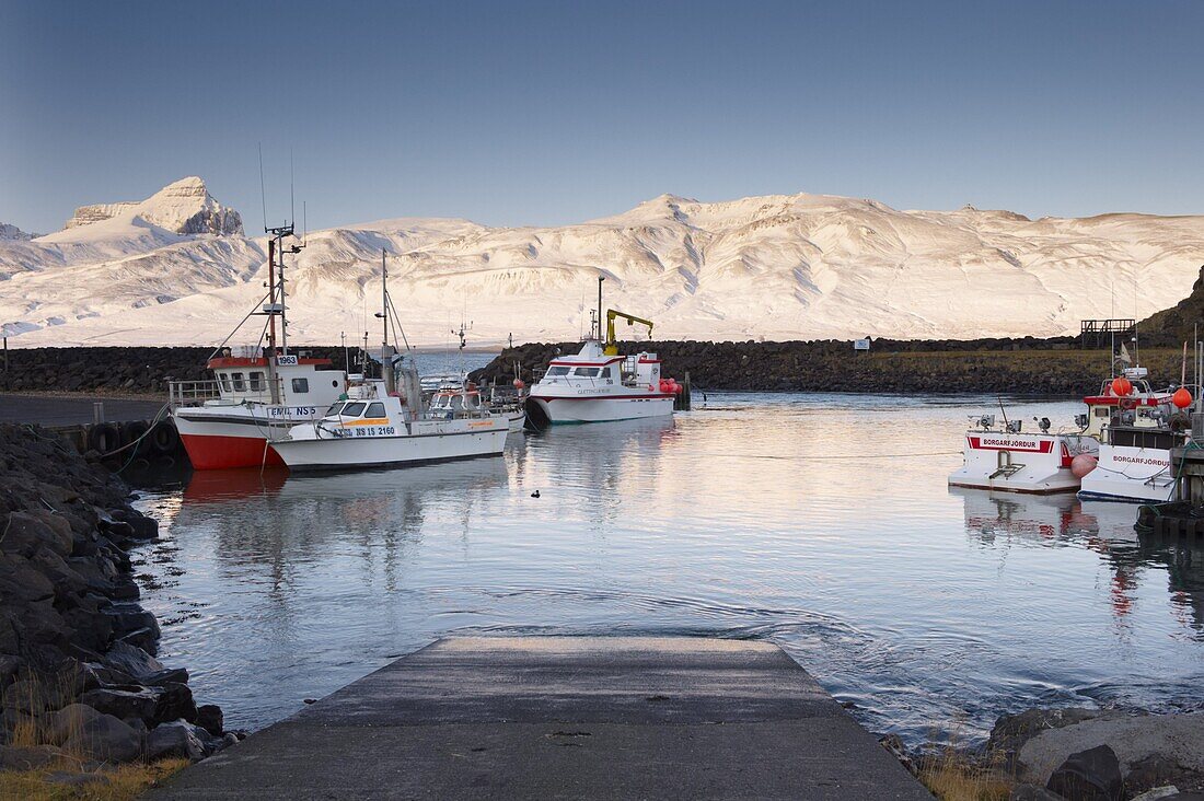 Fishing harbour at Hofn, near Bakkagerdi in Borgarfjordur Eystri fjord, Mount Dyrfjoll (Door mountain), 1136m, in background, East Fjords, Iceland, Polar Regions