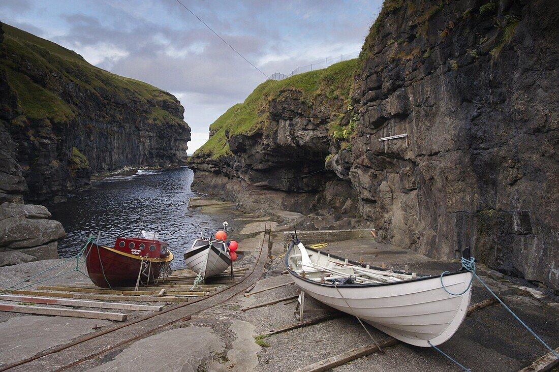 Gjogv harbour, set in a 200m-long natural cleft in the rock, Eysturoy, Faroe Islands (Faroes), Denmark, Europe