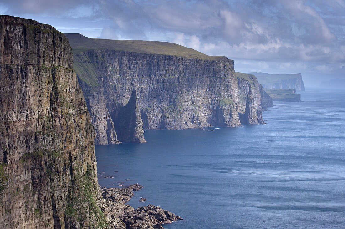High cliffs between 200 and 300m high, on west coast of Sandoy, Svartskorardrangur and Oknadalsdrangur sea stacks, Sandoy, Faroe Islands (Faroes), Denmark, Europe