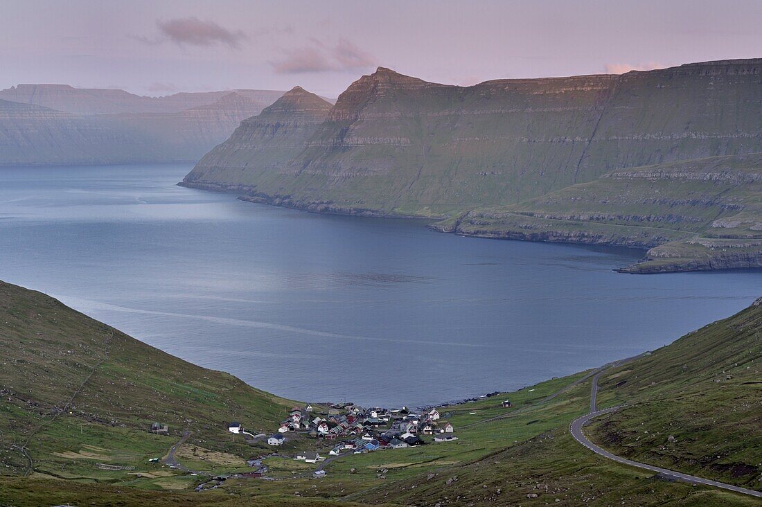 Funningur in Funningsfjordur, with view on Eysturoy and Kalsoy (in the distance) steep hills, at sunset. Eysturoy, Faroe Islands (Faroes), Denmark, Europe