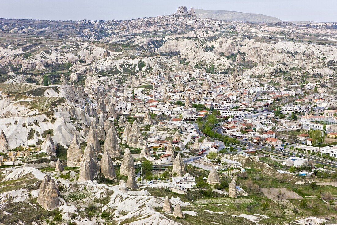 Aerial of the town of Goreme with the Rock Castle of Uchisar on the horizon,  Cappadocia,  Anatolia,  Turkey,  Asia Minor,  Eurasia