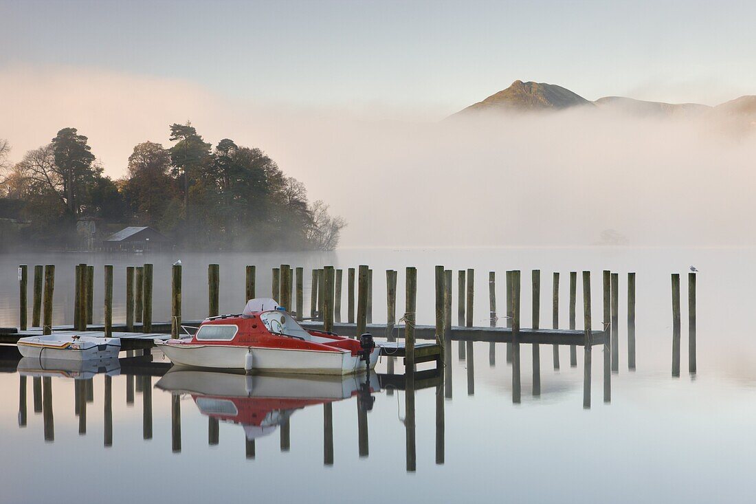 Tethered boats on Derwent Water on a misty autumn morning,  Lake District National Park,  Cumbria,  England,  United Kingdom,  Europe