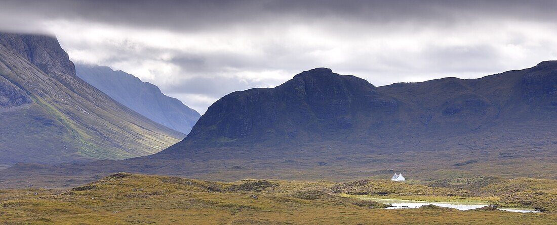 Whitewashed cottage on desolate moorland near Sligachan, Isle of Skye, Highland, Scotland, United Kingdom, Europe