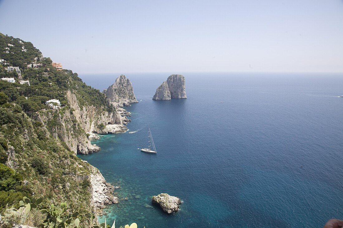 The coast line of the island of Capri, with the famous Faraglioni rocks on the back ground, Capri, Bay of Naples, Italy, Europe