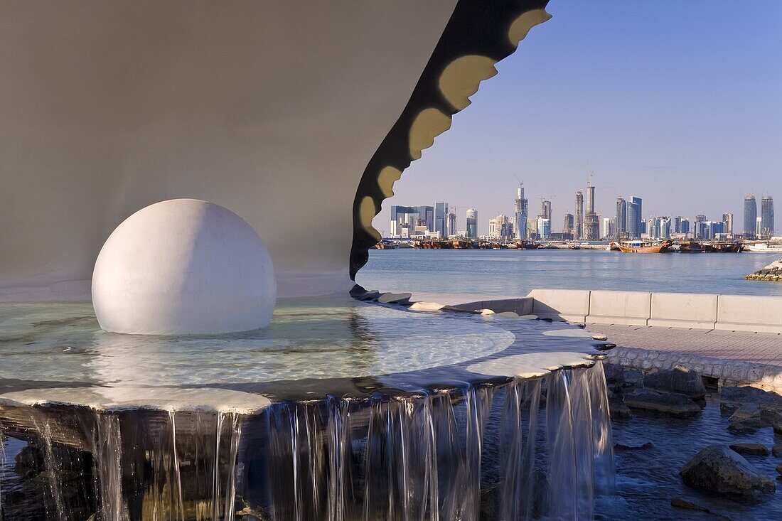 Pearl Monument on the Corniche of Doha Bay with the centra business district of the West Bay on the horizon, Doha, Qatar, Middle East