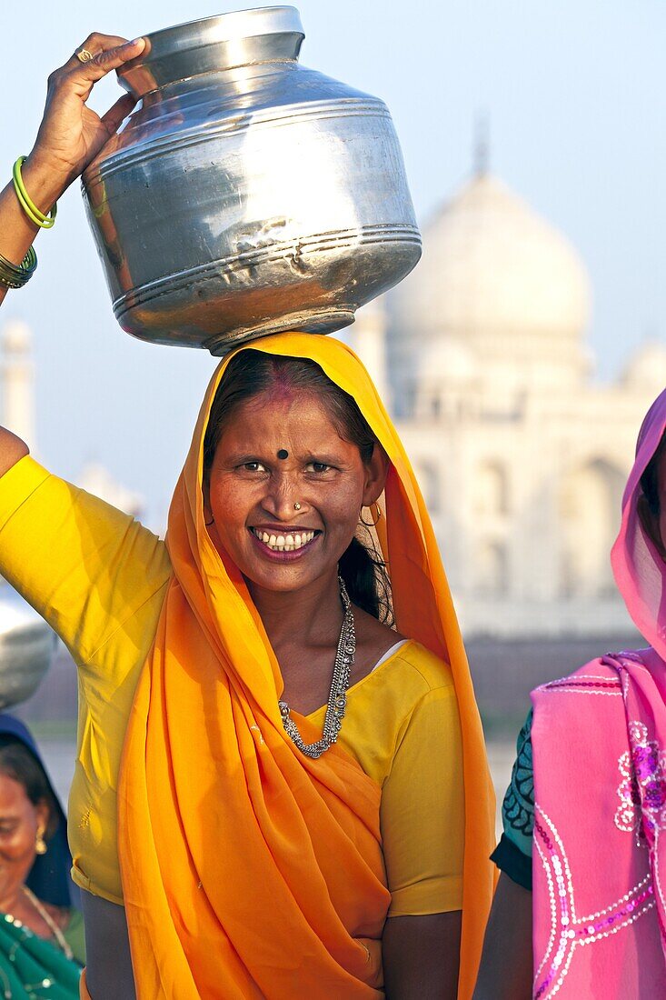 Woman carrying water pot on her head in front of the Taj Mahal, UNESCO World Heritage Site, Agra, Uttar Pradesh state, India, Asia