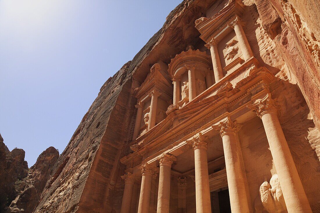 The facade of the Treasury (Al Khazneh) carved into the red rock at Petra, UNESCO World Heritage Site, Jordan, Middle East