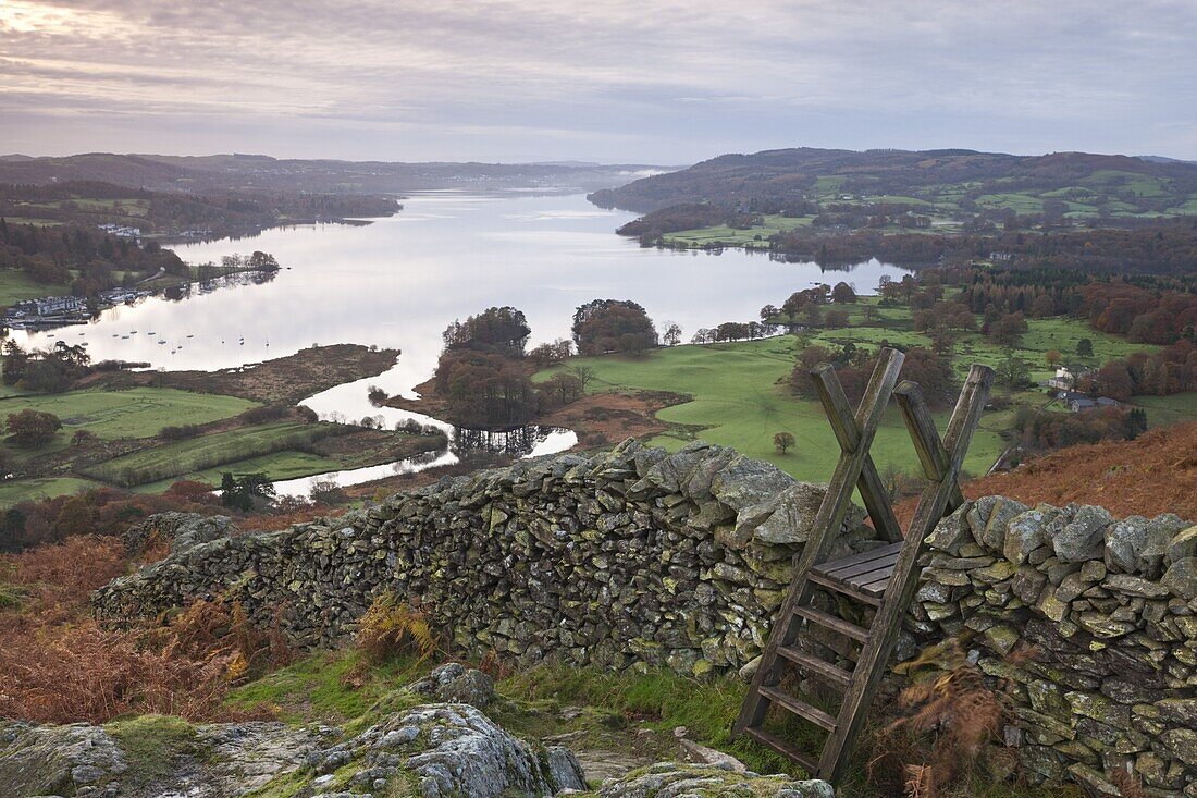 Dry stone wall and wooden stile above Lake Windermere, Lake District National Park, Cumbria, England, United Kingdom, Europe