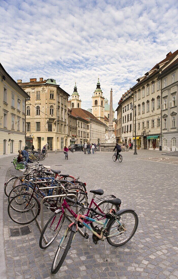 Bicycles parked by the Robba Fountain with the Cathedral of St. Nicholas in the background, Ljubljana, Slovenia, Europe