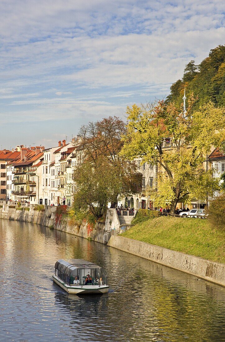 River cruise boat on the Ljubljanica River in autumn, Ljubljana, Slovenia, Europe