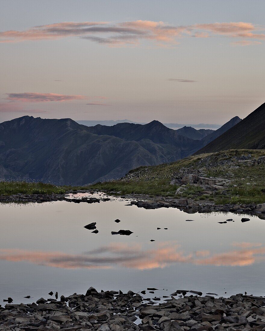 Pink clouds at dawn reflected in a tarn near Stony Pass, San Juan National Forest, Colorado, United States of America, North America