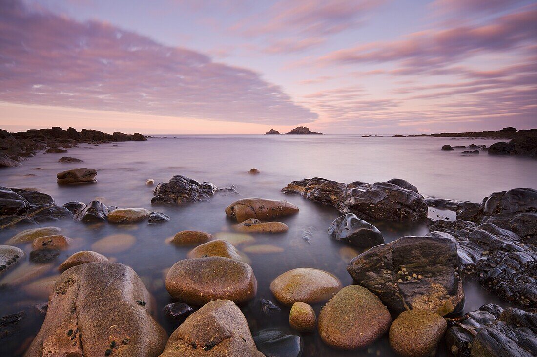 The Brisons on the horizon from the shores of Priests Cove, Cape Cornwall, Cornwall, England, United Kingdom, Europe