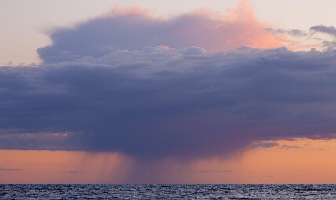Heavy rainclouds at sunset over the English Channel, viewed from the Dorset Coast, Dorset, England, United Kingdom, Europe