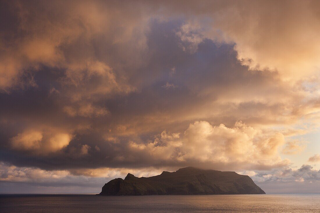 Spectacular sunset skies above the island of Mykines, Faroe Islands, Denmark, Europe