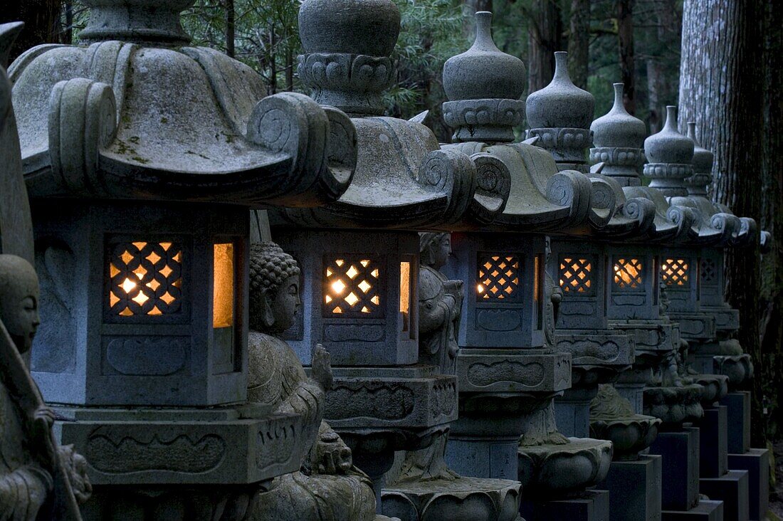 Row of lighted stone lanterns in the Okunoin Temple cemetery at Koyasan (Mount Koya), Wakayama, Japan, Asia