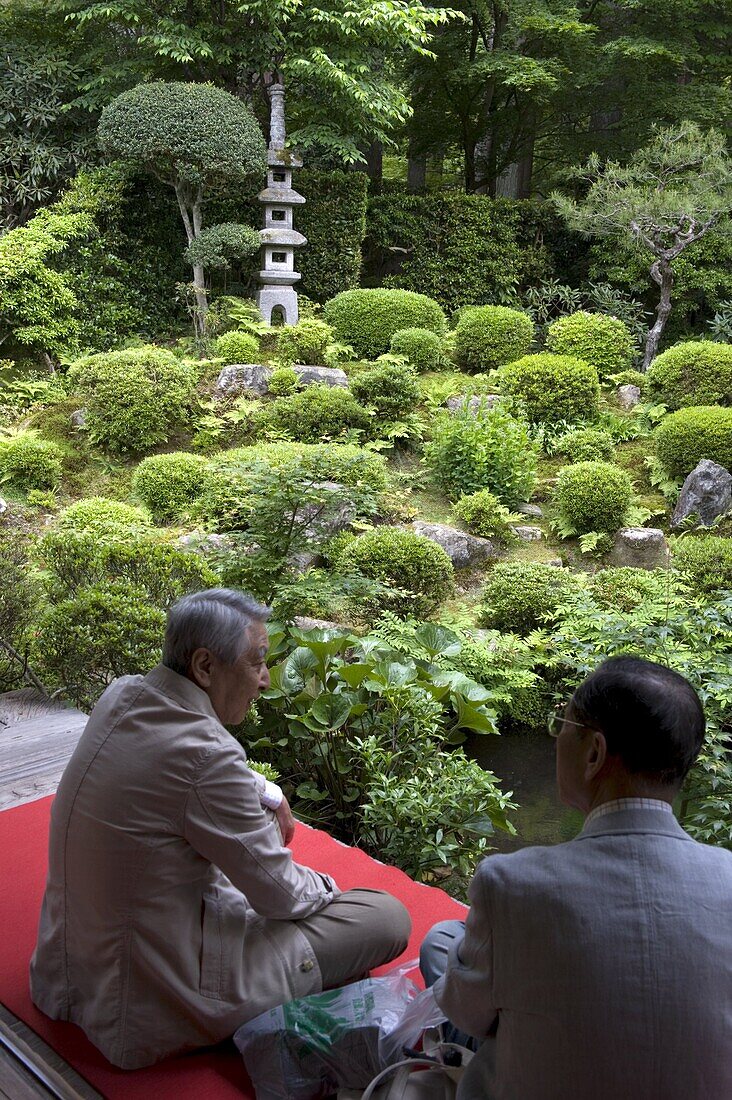 Visitors relaxing at a Zen meditation garden at Sanzenin Temple in Ohara, Kyoto, Japan, Asia