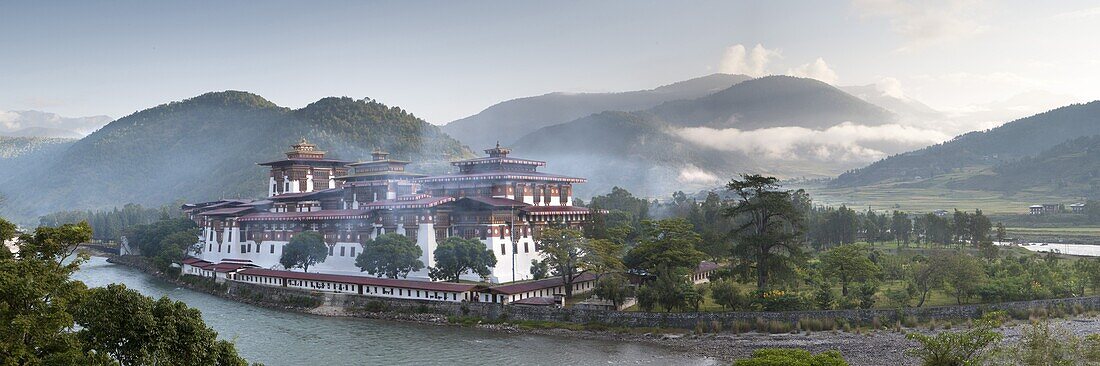 Misty dawn view of the Punakha Dzong located at the junction of the Mo Chhu (Mother River) and Pho Chhu (Father River) in the Punakha Valley, Bhutan, Himalayas, Asia