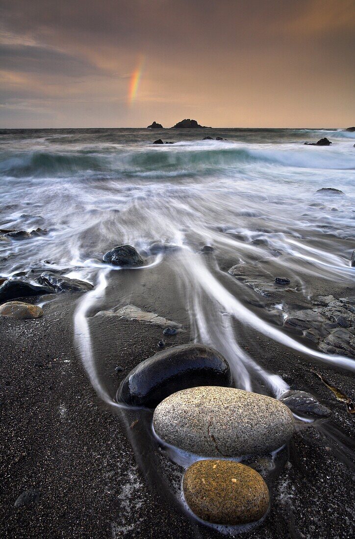 Pebbles on the beach at sunrise, Porth Nanven, Cornwall, England, United Kingdom, Europe
