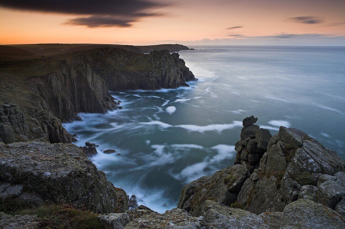 Swirling tide around the base of the huge cliffs of Land's End, Cornwall, England, United Kingdom, Europe