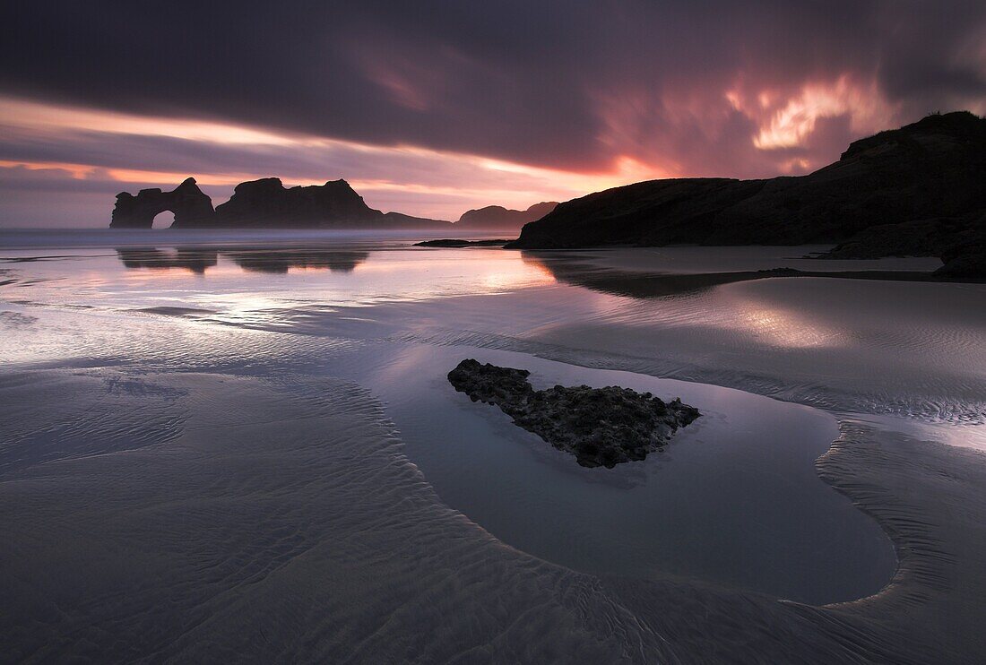 A spectacular sunrise on the beautiful Wharariki Beach, South Island, New Zealand, Pacific
