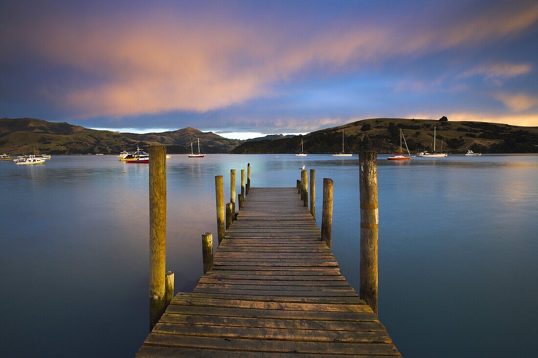 Early morning beside a jetty overlooking Akaroa harbour, Canterbury, South Island, New Zealand, Pacific