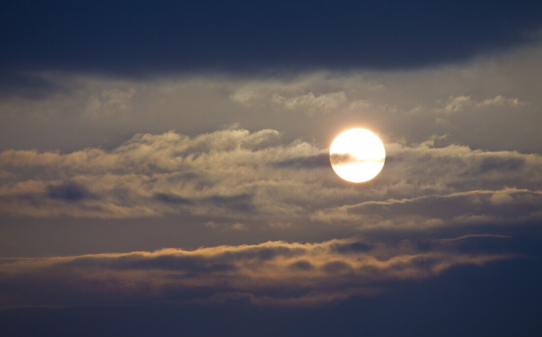 Early morning sun shining behind clouds, United Kingdom, Europe