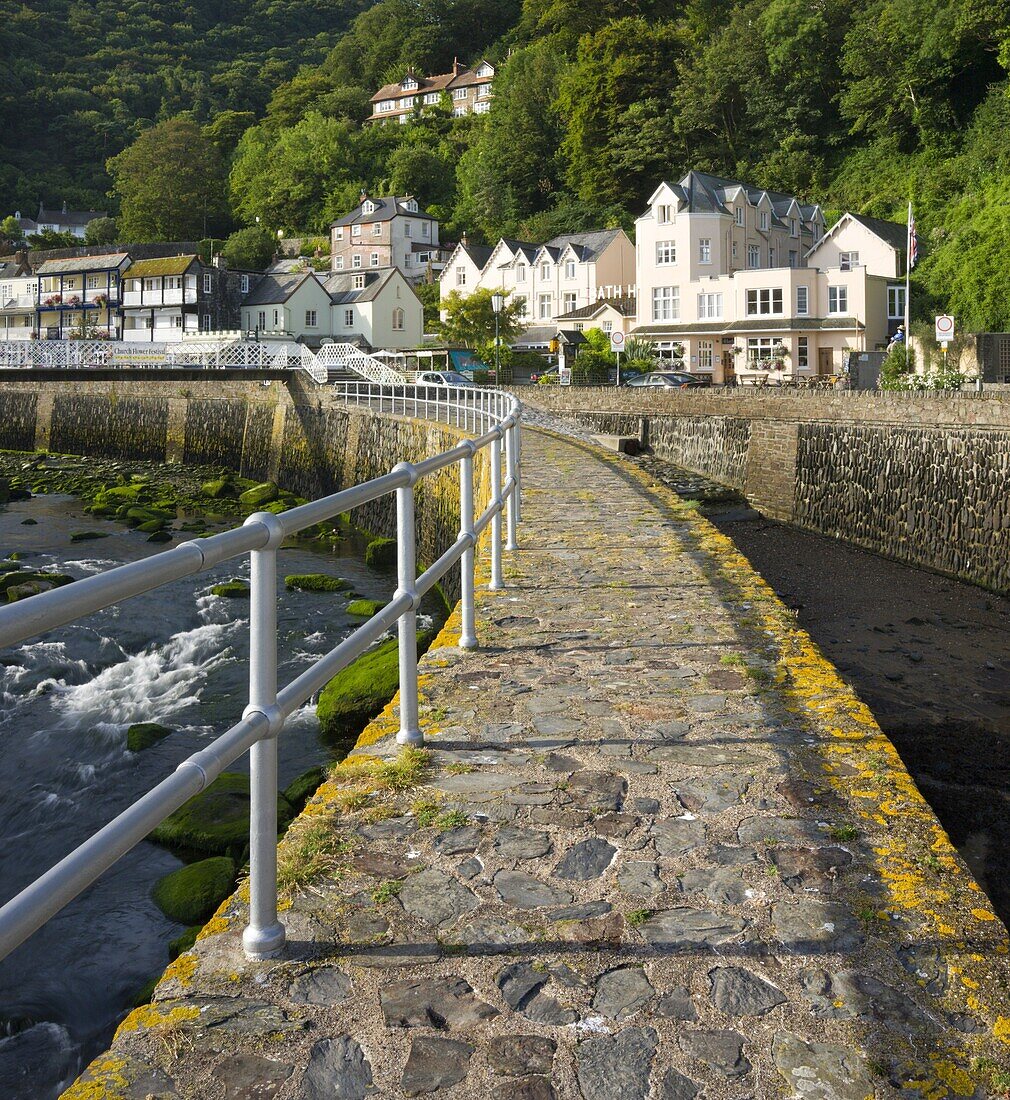 Stone harbour wall and village of Lynmouth on a summer morning, Exmoor National Park, Devon, England, United Kingdom, Europe