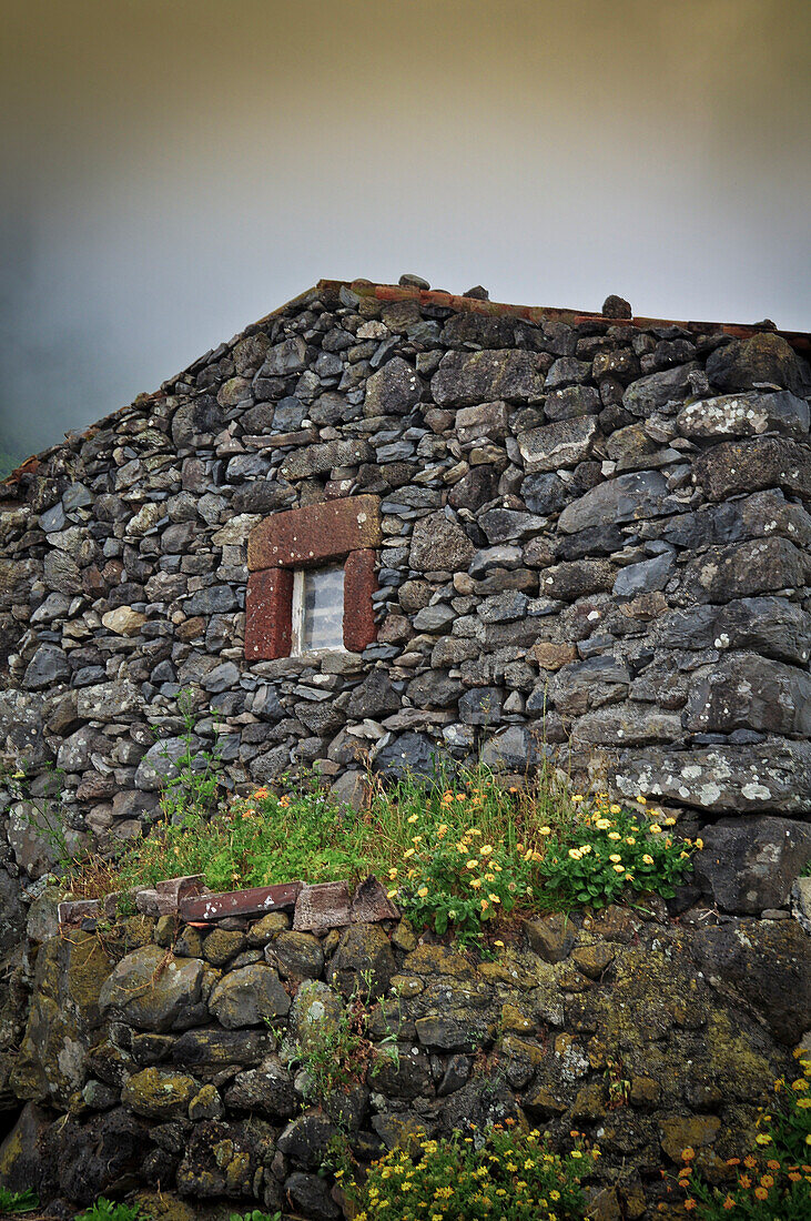 Traditional stone house and thunderstorm clouds, between Faja Grande and Fajazinha, Island of Flores, Azores, Portugal, Europe, Atlantic Ocean