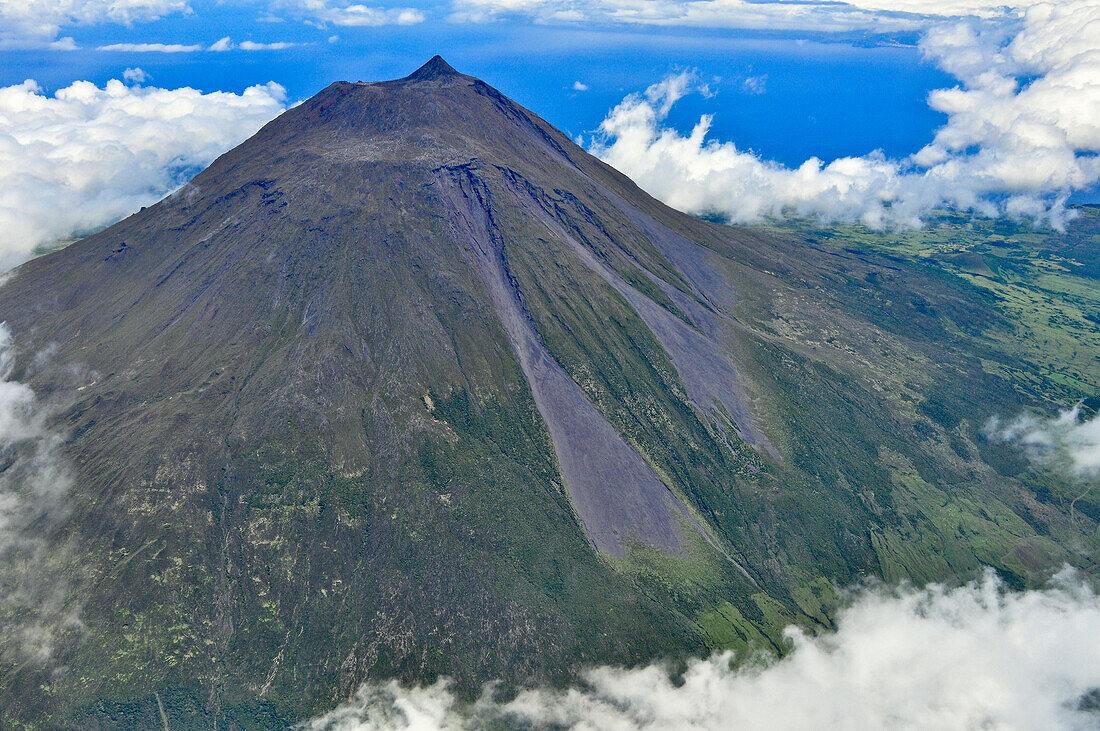 Aerial of volcano Montanha do Pico, Mount Pico with summit Pico Pequeno and crater above clouds, highest mountain of Portugal, stratovolcano, Island of Pico, Azores, Portugal, Europe, Atlantic Ocean