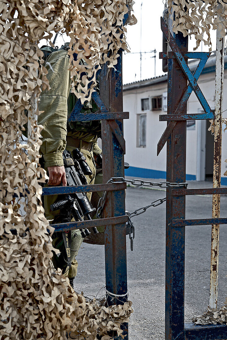 Soldat hinter einem verketteten Tor, Grenze von Israel zum Libanon, Israel