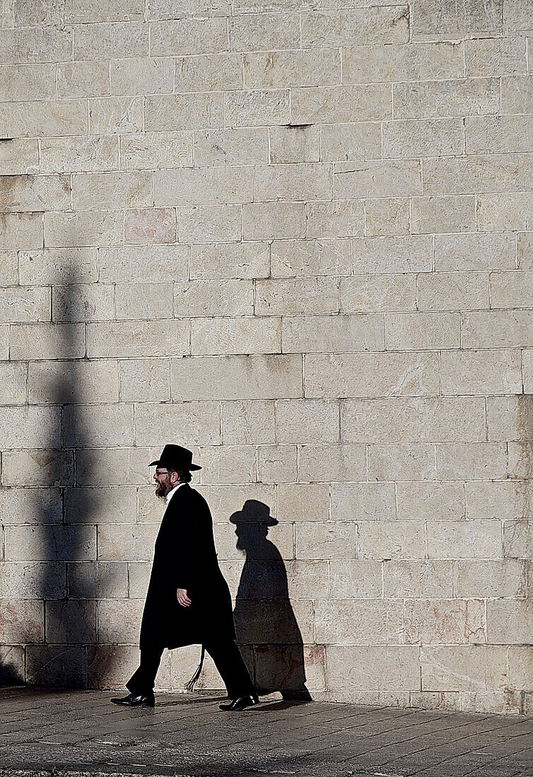 Rabbi walking along a wall, Jerusalem, Israel