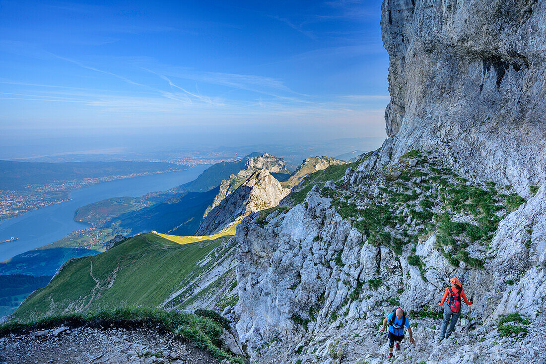 Persons hiking at La Tournette, Lac d'Annecy in background, La Tournette, Haute-Savoie, France